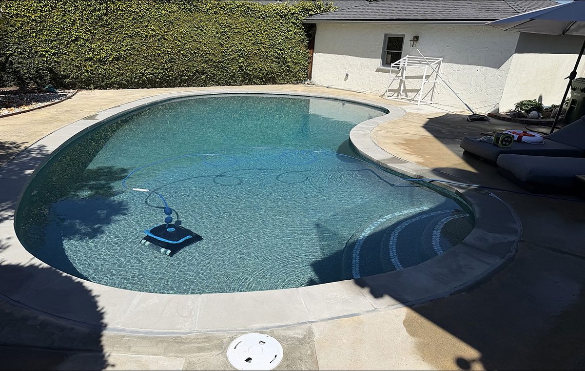 Clear blue backyard pool after weekly service by ASJEM Pools