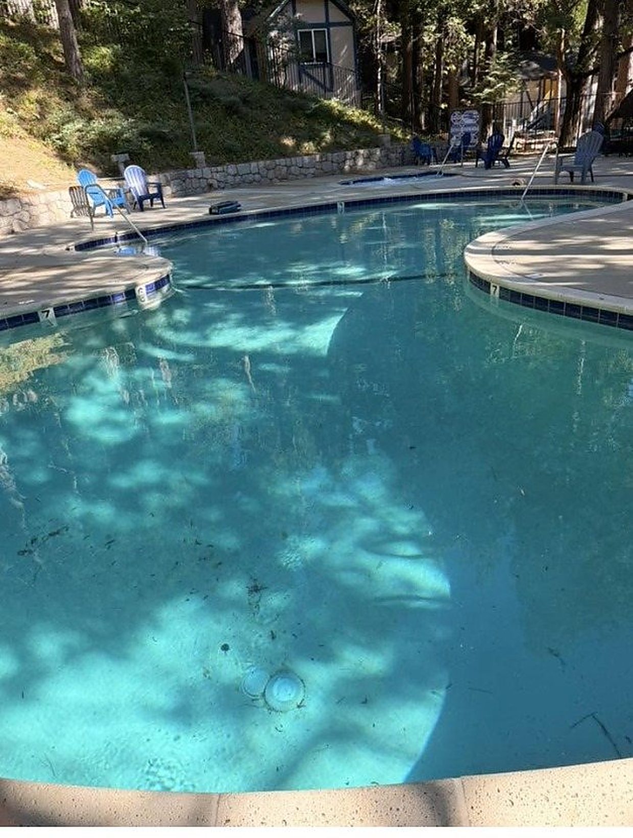 The same pool, clear and blue, after ASJEM Pools drained and cleaned it